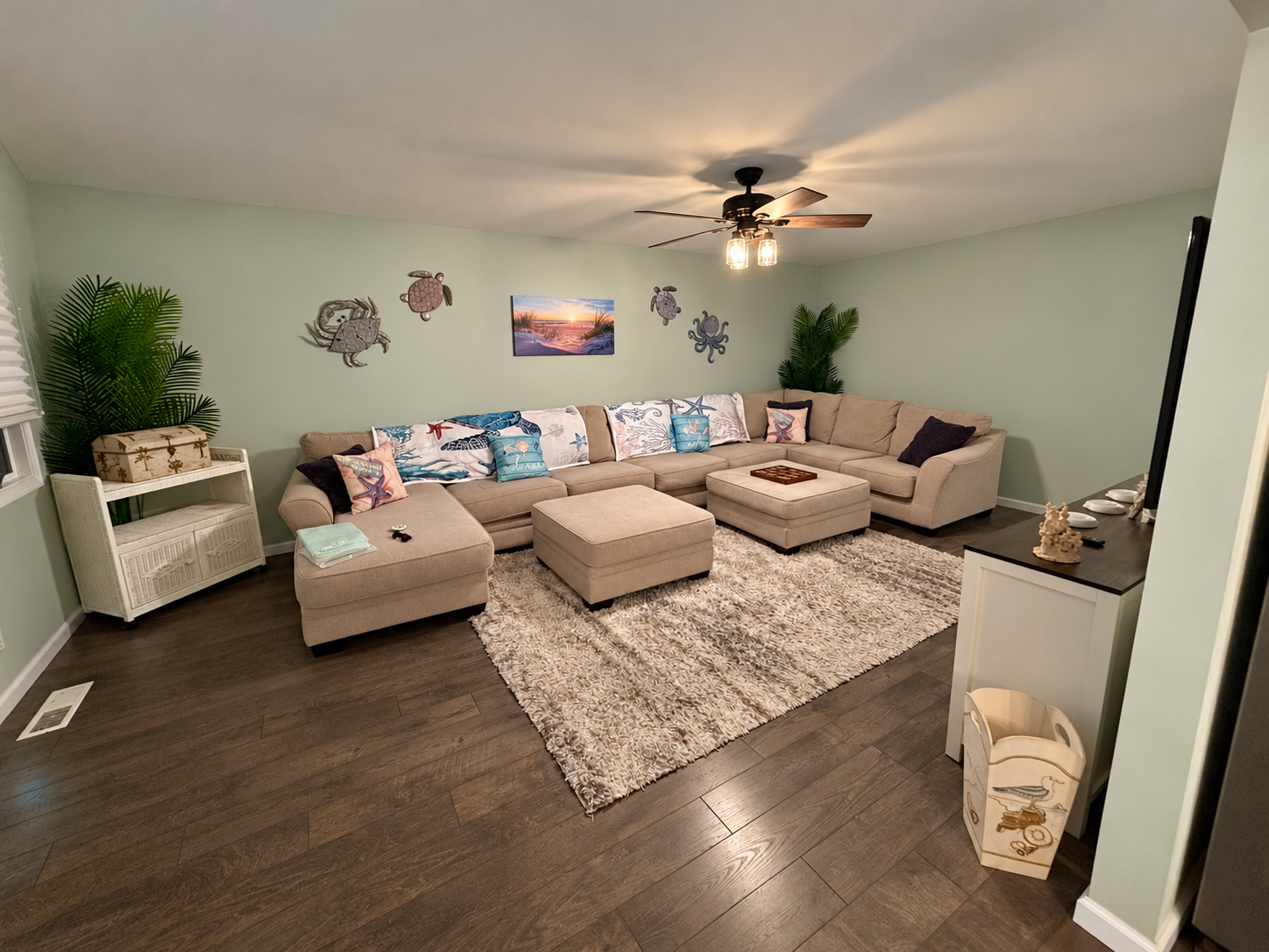 Bennett By the Bay living room with a large sectional, coastal cushions and a soft area rug